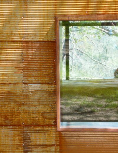 A rustic window with a view of a serene natural landscape.