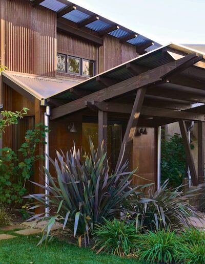 Sustainable modern home with solar panels and drought-tolerant landscaping.