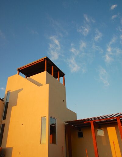 Modern residential building against a blue sky at sunset.