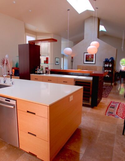Spacious, modern kitchen with high ceilings, wooden cabinets, and central island.